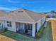 Single-story house with screened patio, gray roof, and well-manicured lawn at 5365 Nw 46Th Lane Rd, Ocala, FL 34482