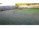 Large grassy backyard area with a wooden fence at 5465 Ne 12Th Ave, Ocala, FL 34479