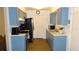 Galley kitchen with stainless steel appliances and blue cabinets at 5465 Ne 12Th Ave, Ocala, FL 34479