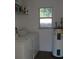 Laundry room with washer, dryer, and storage shelf at 5465 Ne 12Th Ave, Ocala, FL 34479