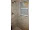 Shower stall with tiled walls and a handheld shower head at 5465 Ne 12Th Ave, Ocala, FL 34479