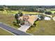 Aerial view of a house with a three-car garage and landscaping at 6861 Sw 179Th Avenue Rd, Dunnellon, FL 34432