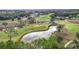 Aerial view of a golf course with a pond and waterfall feature at 6861 Sw 179Th Avenue Rd, Dunnellon, FL 34432