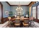 Formal dining room with an oval table, chandelier, and blue wallpaper at 6861 Sw 179Th Avenue Rd, Dunnellon, FL 34432