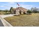 House exterior showcasing a two-car garage and manicured lawn at 6861 Sw 179Th Avenue Rd, Dunnellon, FL 34432