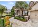 Front entrance of charming house with stone accents and lush landscaping at 6861 Sw 179Th Avenue Rd, Dunnellon, FL 34432