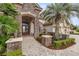 Stone and stucco house exterior with a double door entry and palm trees at 6861 Sw 179Th Avenue Rd, Dunnellon, FL 34432