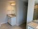 Bathroom featuring a single vanity, framed mirror, neutral walls and luxury vinyl plank flooring at 7 Nw 45Th Loop, Ocala, FL 34470