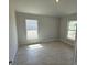 A naturally lit bedroom with white trim, luxury vinyl plank flooring, and neutral walls at 7 Nw 45Th Loop, Ocala, FL 34470
