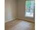 Bright bedroom with neutral carpet, trim and walls, and a natural light-filled window at 7 Nw 45Th Loop, Ocala, FL 34470