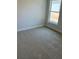 Comfortable bedroom featuring neutral carpet, ample natural light, and a large window at 7 Nw 45Th Loop, Ocala, FL 34470