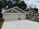 Charming single-story home featuring a three-car garage, stone accents, and a well-manicured lawn at 7 Nw 45Th Loop, Ocala, FL 34470