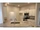 Modern kitchen featuring stainless steel appliances, granite countertops, and ample cabinet space at 7 Nw 45Th Loop, Ocala, FL 34470