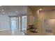 An open-concept living space with white walls, luxury vinyl plank flooring, and a kitchen with stone countertops at 7 Nw 45Th Loop, Ocala, FL 34470