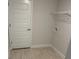 A simple laundry room with white walls, luxury vinyl plank flooring, and a shelving unit at 7 Nw 45Th Loop, Ocala, FL 34470