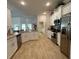 Modern kitchen with white cabinets, granite countertops, and stainless steel appliances at 7 Nw 45Th Loop, Ocala, FL 34470