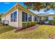 House exterior with screened-in porch and well-manicured yard at 7316 Sw 94Th Ct, Ocala, FL 34481