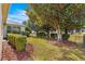 Landscaped backyard with lush greenery and mature trees at 7316 Sw 94Th Ct, Ocala, FL 34481