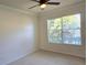 Bedroom with carpet flooring, a ceiling fan and a window letting in natural light at 7316 Sw 94Th Ct, Ocala, FL 34481
