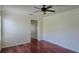 Bedroom featuring hardwood floors, light walls, and large windows, creating a warm and inviting space at 7316 Sw 94Th Ct, Ocala, FL 34481