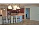 Kitchen with stainless appliances, breakfast bar with seating, and pendant lighting; open to adjacent rooms at 7316 Sw 94Th Ct, Ocala, FL 34481