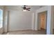 Bright, open living room with neutral walls and tile flooring, illuminated by a ceiling fan and natural light at 7316 Sw 94Th Ct, Ocala, FL 34481