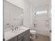 Bright bathroom featuring a large vanity with quartz counters, a shower over tub, and tile floors at 7884 Sw 59Th St, Ocala, FL 34474