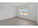 Bright bedroom showcasing neutral wall-to-wall flooring and outside view window offering relaxation at 7884 Sw 59Th St, Ocala, FL 34474