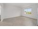 Bright bedroom featuring light, neutral flooring and a window offering outside community views at 7884 Sw 59Th St, Ocala, FL 34474