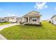 Well-kept property showcasing a green lawn, two-car garage, and welcoming front porch at 7884 Sw 59Th St, Ocala, FL 34474