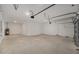 An empty two car garage with concrete floors and a new garage door at 7884 Sw 59Th St, Ocala, FL 34474