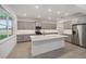 Modern kitchen featuring gray cabinets, a large island, stainless steel appliances, and bright recessed lighting at 7884 Sw 59Th St, Ocala, FL 34474