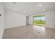 Expansive living room featuring neutral walls, recessed lighting, and sliding glass doors to the outdoors at 7884 Sw 59Th St, Ocala, FL 34474