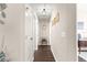 Bright hallway with dark hardwood floors and decorative accents at 8120 Sw 56Th Ter, Ocala, FL 34476