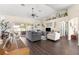 Spacious living room with hardwood floors, gray and beige sofas, and sliding doors to a patio at 8120 Sw 56Th Ter, Ocala, FL 34476