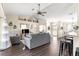 Living room with dark hardwood floors, gray sofa, and a view into the kitchen at 8120 Sw 56Th Ter, Ocala, FL 34476