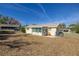 Home's backyard view, featuring a screened patio and fenced yard at 8274 Sw 106Th Pl, Ocala, FL 34481