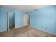 Bedroom with light blue walls, carpeting, and a large closet at 8274 Sw 106Th Pl, Ocala, FL 34481