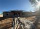 Back of unfinished house under construction, block walls, and a blue tarp roof at 8781 Se 161St Pl, Summerfield, FL 34491