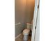 Small bathroom with toilet and grab bars at 9143 Sw 70Th Loop, Ocala, FL 34481