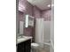 Bathroom with granite countertop, dark vanity, and patterned wall paper at 9143 Sw 70Th Loop, Ocala, FL 34481