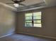 Light filled bedroom with a tray ceiling, carpeted floors, and a ceiling fan at 9143 Sw 70Th Loop, Ocala, FL 34481