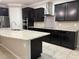 Modern kitchen featuring dark wood cabinets, granite countertops, and a large island at 9143 Sw 70Th Loop, Ocala, FL 34481