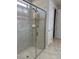 Bathroom shower with glass door and tiled walls, featuring a built-in soap dish at 9143 Sw 70Th Loop, Ocala, FL 34481