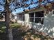 A backyard exterior view has a screened-in porch with shaded sunlight at 9686 Sw 92Nd Place Rd, Ocala, FL 34481