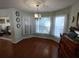 View of bright breakfast nook featuring large windows, hardwood floors, and traditional decor at 9686 Sw 92Nd Place Rd, Ocala, FL 34481