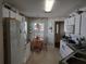 View of a kitchen featuring white appliances, a dining table, and lots of storage at 9686 Sw 92Nd Place Rd, Ocala, FL 34481