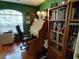 Office with a large desk and a bookcase filled with books at 9686 Sw 92Nd Place Rd, Ocala, FL 34481