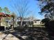 Relaxing backyard featuring screened pool area, wooden pergola, and mature trees at 10870 Sw 47Th Ct, Ocala, FL 34476