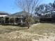 Large backyard featuring a screened-in pool area, lush greenery, and plenty of space for outdoor activities at 10870 Sw 47Th Ct, Ocala, FL 34476